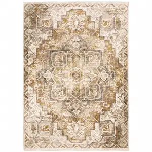 Photo of Gold And Ivory Oriental Power Loom Stain Resistant Area Rug With Fringe