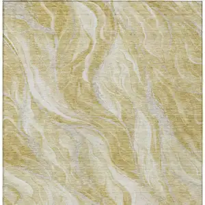 Photo of Gold Beige And Ivory Abstract Washable Indoor Outdoor Area Rug