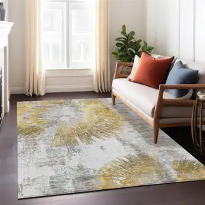 Photo of Gold Beige And Ivory Abstract Washable Indoor Outdoor Area Rug