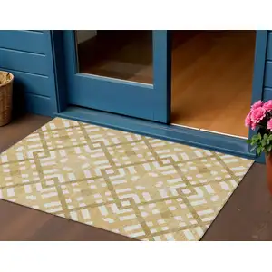 Photo of Gold Beige And Tan Geometric Washable Indoor Outdoor Area Rug