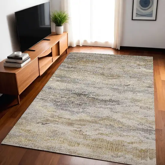 Gold Gray And Ivory Abstract Stain Resistant Area Rug Photo 1