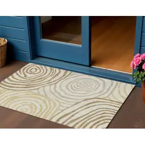 Photo of Gold Ivory And Beige Abstract Washable Indoor Outdoor Area Rug