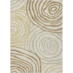 Photo of Gold Ivory And Beige Abstract Washable Indoor Outdoor Area Rug