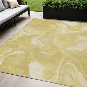 Photo of Gold Wheat And Ivory Abstract Washable Indoor Outdoor Area Rug