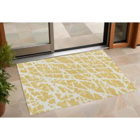 Gold and White Abstract Washable Non Skid Indoor Outdoor Area Rug Photo 1