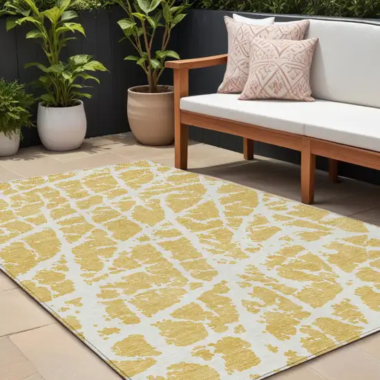 Gold and White Abstract Washable Non Skid Indoor Outdoor Area Rug Photo 1