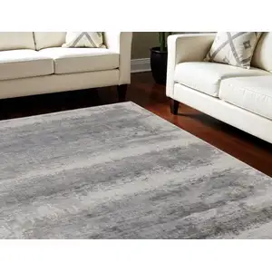 Photo of Gray Abstract Power Loom Area Rug With Fringe