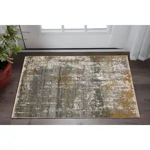 Photo of Gray And Gold Abstract Area Rug With Fringe