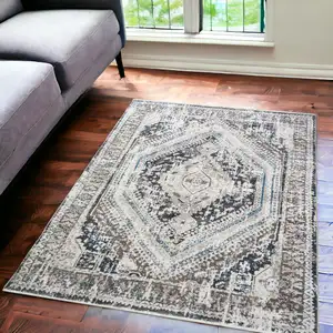 Photo of Gray Beige and Blue Geometric Distressed Area Rug With Fringe