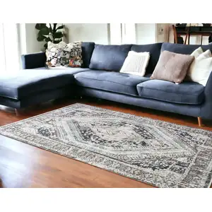 Photo of Gray Beige and Blue Geometric Distressed Area Rug With Fringe