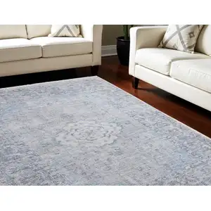 Photo of Gray Blue and Ivory Oriental Hand Woven Distressed Area Rug With Fringe