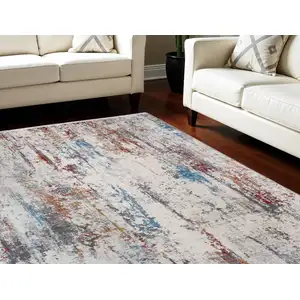 Photo of Gray Blue and Red Abstract Power Loom Area Rug With Fringe