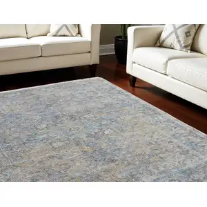 Photo of Gray Blue and Tan Abstract Hand Woven Distressed Area Rug With Fringe