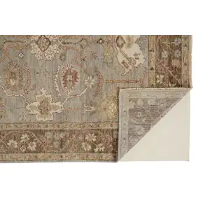 Photo of Gray Brown And Gold Wool Floral Hand Knotted Stain Resistant Area Rug With Fringe