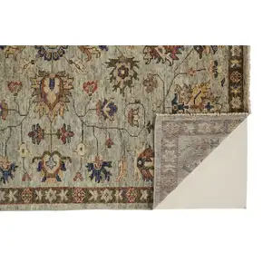 Photo of Gray Gold And Red Wool Floral Hand Knotted Stain Resistant Area Rug With Fringe