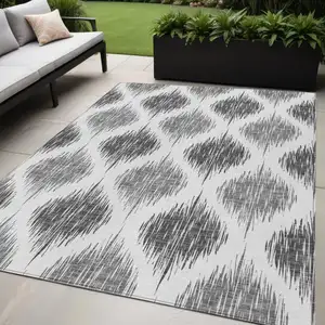 Photo of Gray Ivory And Charcoal Ikat Washable Indoor Outdoor Area Rug