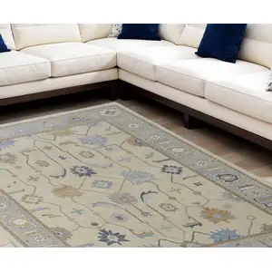 Photo of Gray Ivory and Blue Wool Floral Hand Knotted Area Rug With Fringe