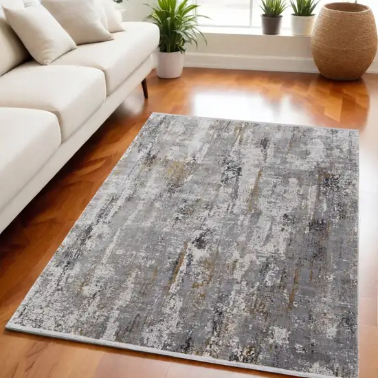 Gray Ivory and Gold Abstract Power Loom Area Rug With Fringe Photo 1