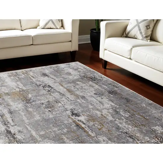 Gray Ivory and Gold Abstract Power Loom Area Rug With Fringe Photo 1