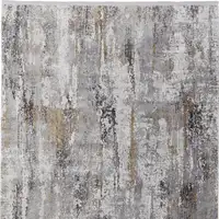 Photo of Gray Ivory and Gold Abstract Power Loom Area Rug With Fringe