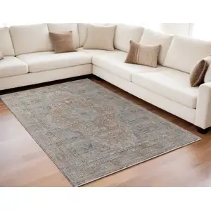 Photo of Gray Ivory and Orange Oriental Power Loom Worn Faded Area Rug With Fringe