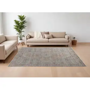 Photo of Gray Ivory and Orange Oriental Power Loom Worn Faded Area Rug With Fringe