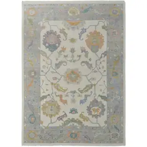 Photo of Gray Ivory and Orange Wool Floral Hand Knotted Area Rug With Fringe