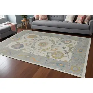 Photo of Gray Ivory and Orange Wool Floral Hand Knotted Area Rug With Fringe