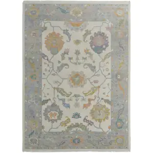 Photo of Gray Ivory and Orange Wool Floral Hand Knotted Area Rug With Fringe