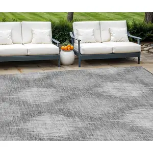 Photo of Gray Silver And Charcoal Ikat Washable Indoor Outdoor Area Rug