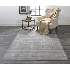 Photo of Gray Taupe And Ivory Abstract Hand Woven Area Rug