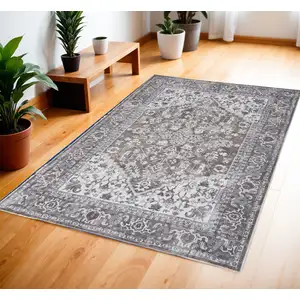 Photo of Green and Ivory Floral Medallion Power Loom Distressed Area Rug