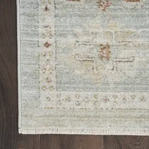 Photo of Green and Ivory Oriental Power Loom Distressed Area Rug With Fringe