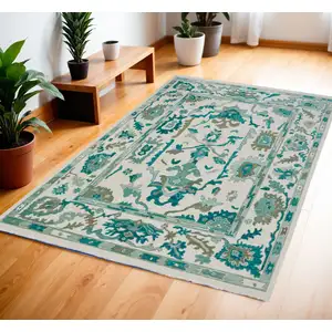 Photo of Green and Ivory Wool Floral Hand Knotted Area Rug With Fringe