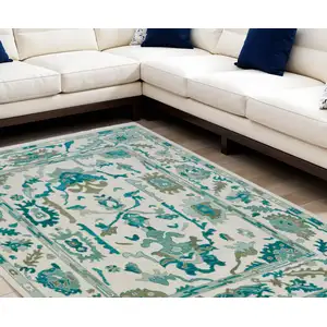 Photo of Green and Ivory Wool Floral Hand Knotted Area Rug With Fringe