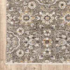 Photo of Grey And Tan Floral Power Loom Stain Resistant Area Rug With Fringe