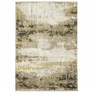 Photo of Grey Gold Black Charcoal And Beige Abstract Power Loom Stain Resistant Area Rug With Fringe