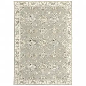 Photo of Grey Ivory Tan Brown And Gold Oriental Power Loom Stain Resistant Area Rug