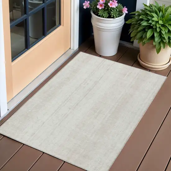 Ivory And Beige Striped Washable Indoor Outdoor Area Rug Photo 1