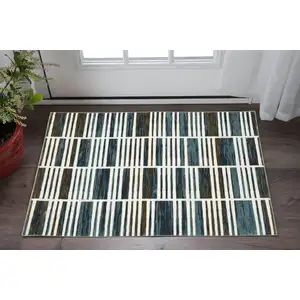 Photo of Ivory And Blue Geometric Area Rug