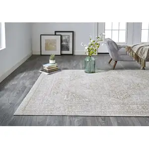 Photo of Ivory And Gold Floral Stain Resistant Area Rug