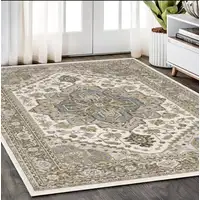 Photo of Ivory And Gold Medallion Distressed Area Rug With Fringe