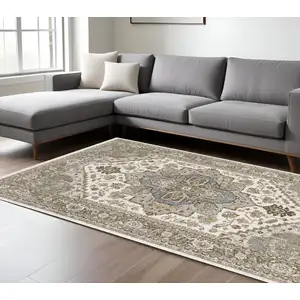 Photo of Ivory And Gold Medallion Distressed Area Rug With Fringe