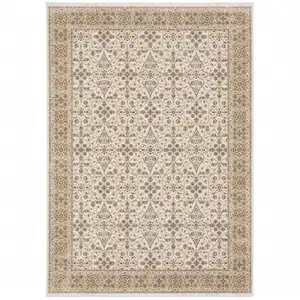 Photo of Ivory And Gold Oriental Power Loom Stain Resistant Area Rug With Fringe