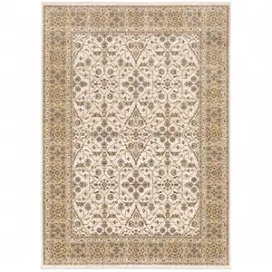 Photo of Ivory And Gold Oriental Power Loom Stain Resistant Area Rug With Fringe