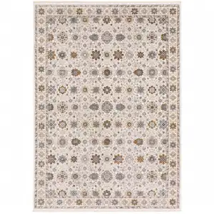 Photo of Ivory And Gold Oriental Power Loom Stain Resistant Area Rug With Fringe