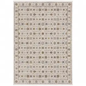 Photo of Ivory And Gold Oriental Power Loom Stain Resistant Area Rug With Fringe