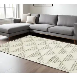 Photo of Ivory And Green Geometric Shag Area Rug With Fringe