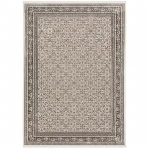 Photo of Ivory And Grey Oriental Power Loom Stain Resistant Area Rug With Fringe