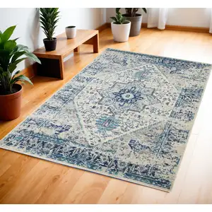 Photo of Ivory And Light Blue Floral Medallion Distressed Area Rug